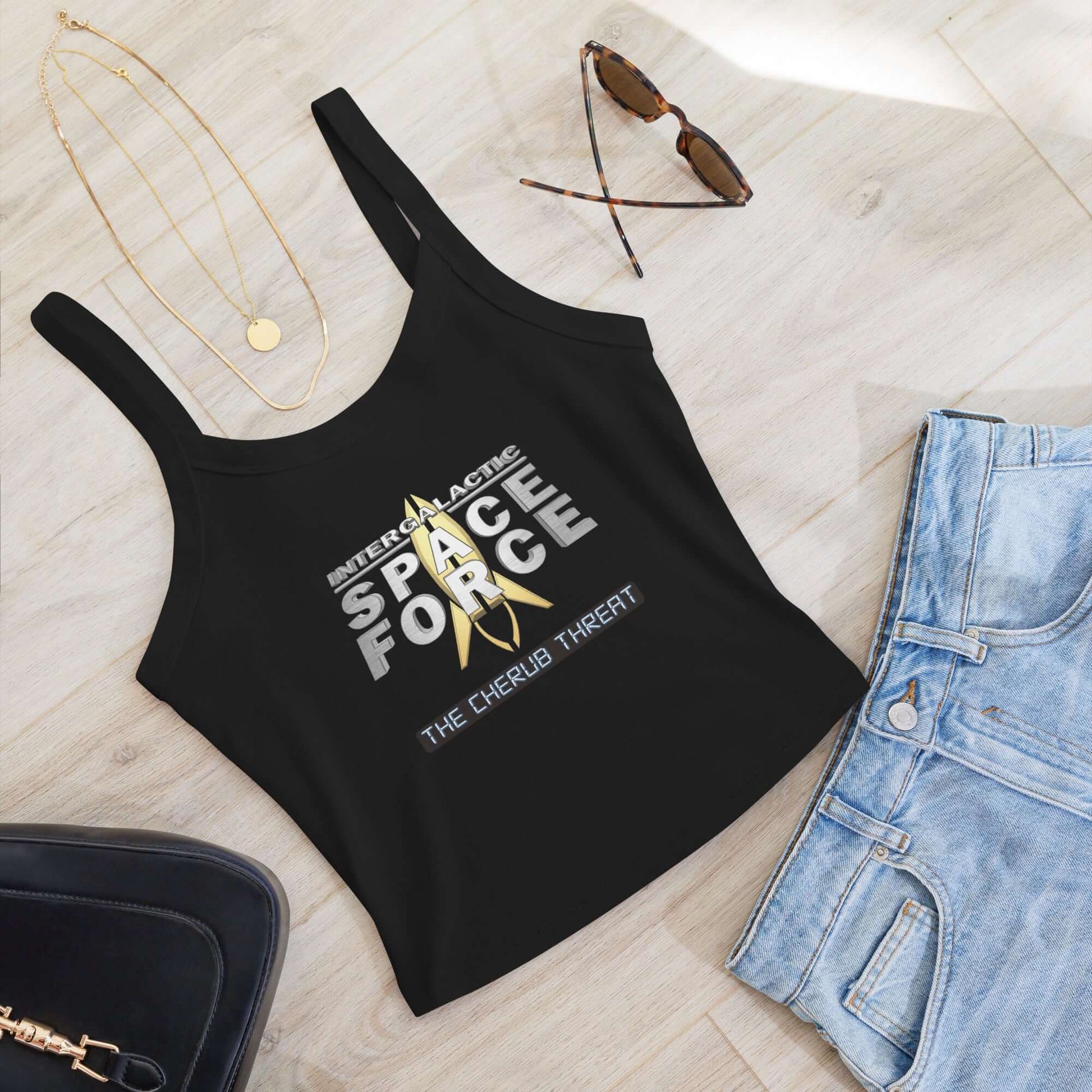 Women's micro-rib tank top with "Intergalactic Space Force 2 - The Cherub Threat" graphic, styled with jeans, sunglasses, and accessories.